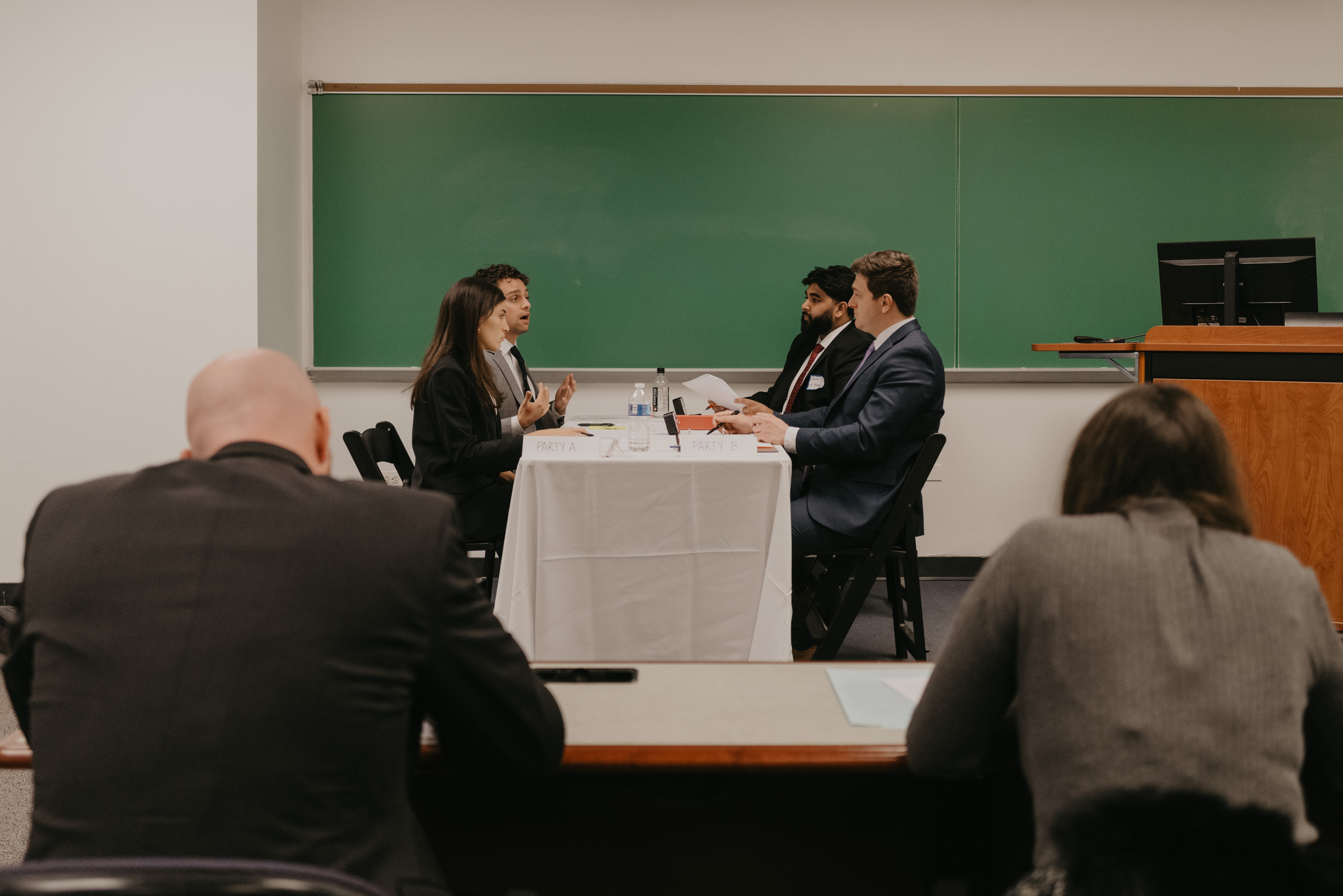 Students negotiating at a table.