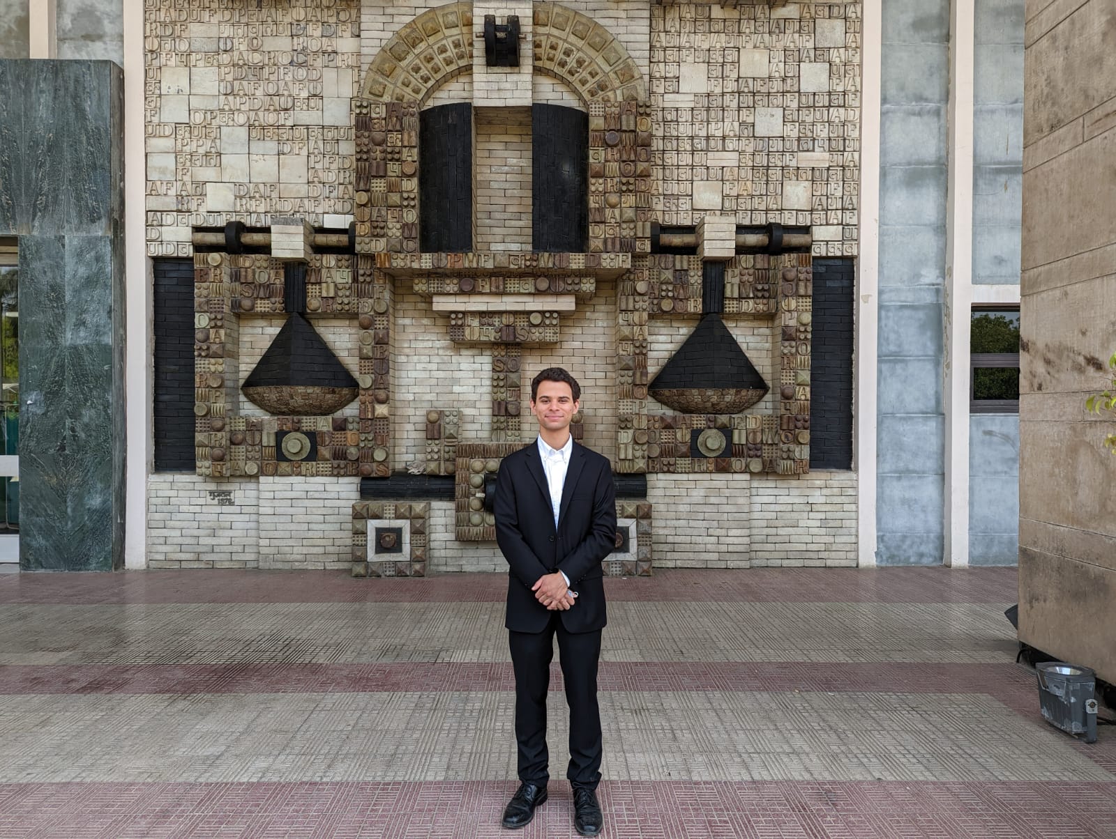 A student standing in a courtyard