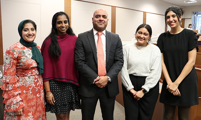 three students with a judge and his clerk