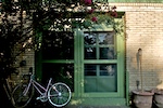Green front door with bike