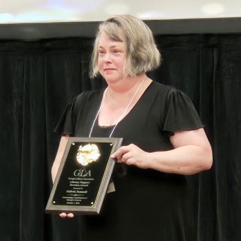 Szilvia Somodi accepts an award for her service to the law library.
